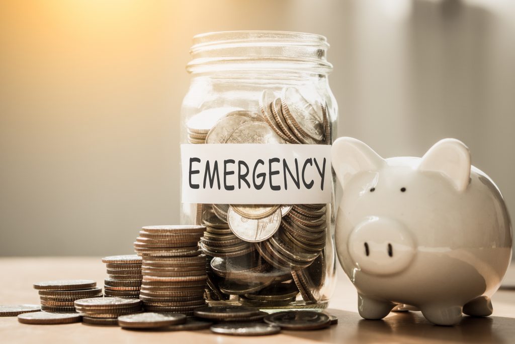 A lot coins in glass money with piggy bank for saving emergency