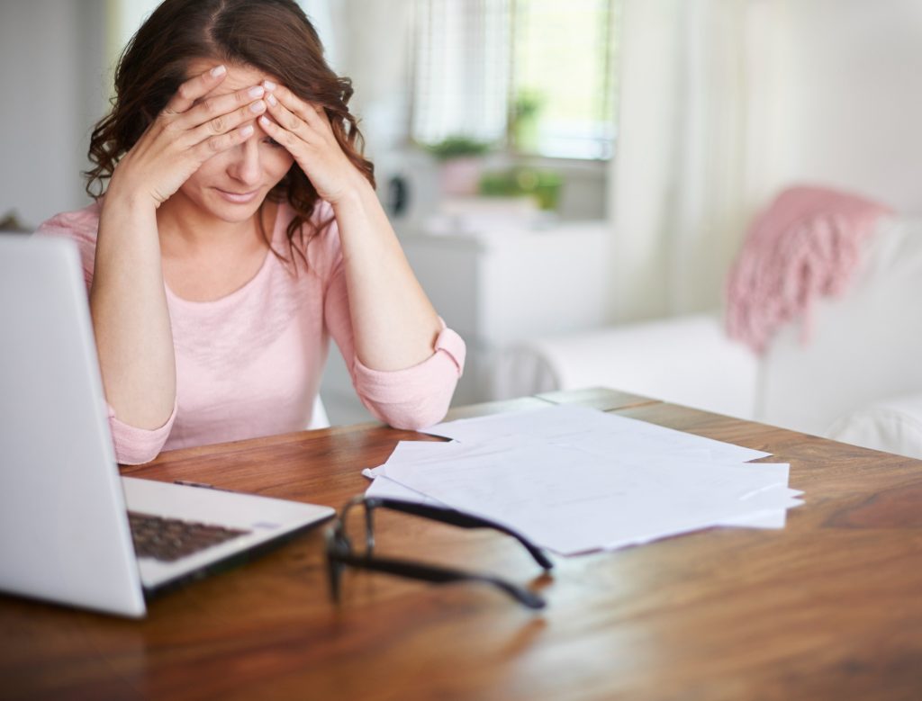 tired woman worried about bills