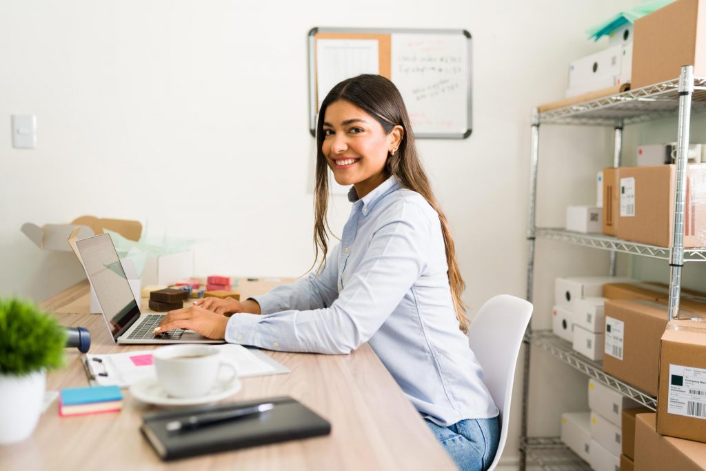 business owner smilling working at office desk