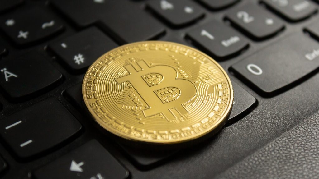 bitcoin on top of laptop