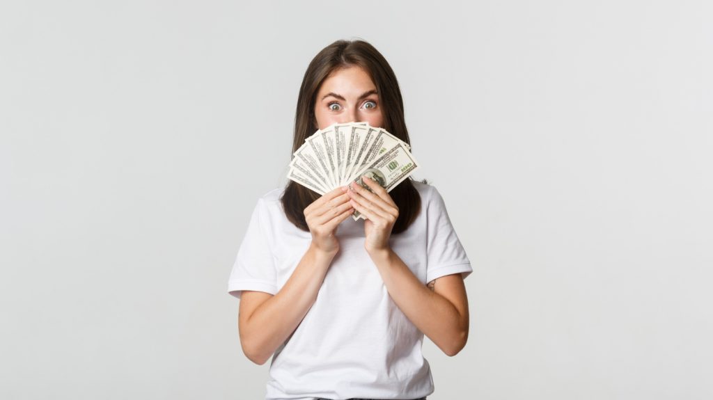 young woman holding money personal loan
