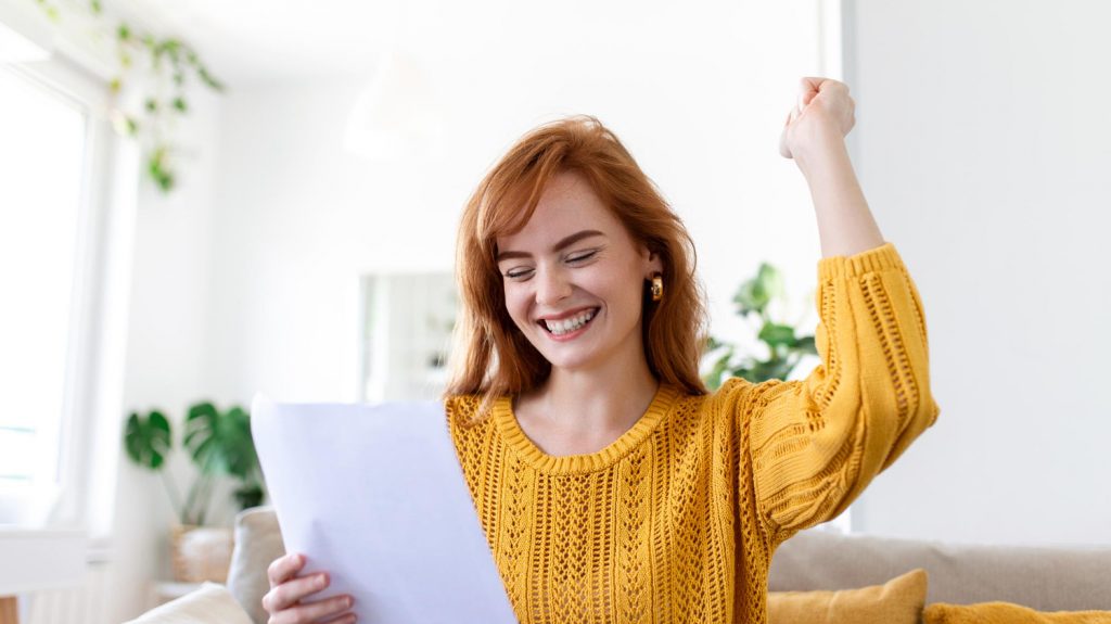 excited young woman gets personal loan approved