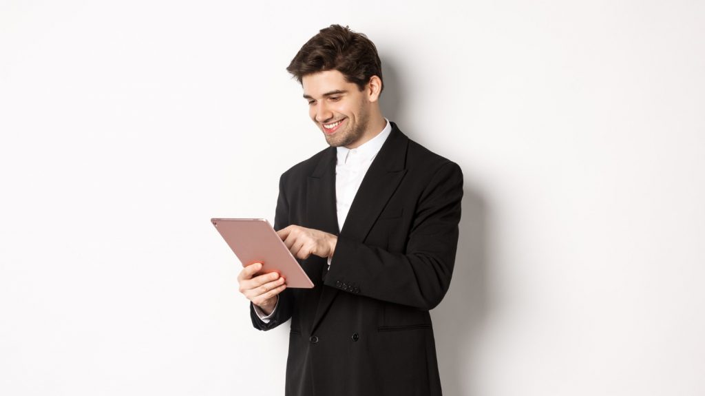 business man in suit holding tablet online brokerage
