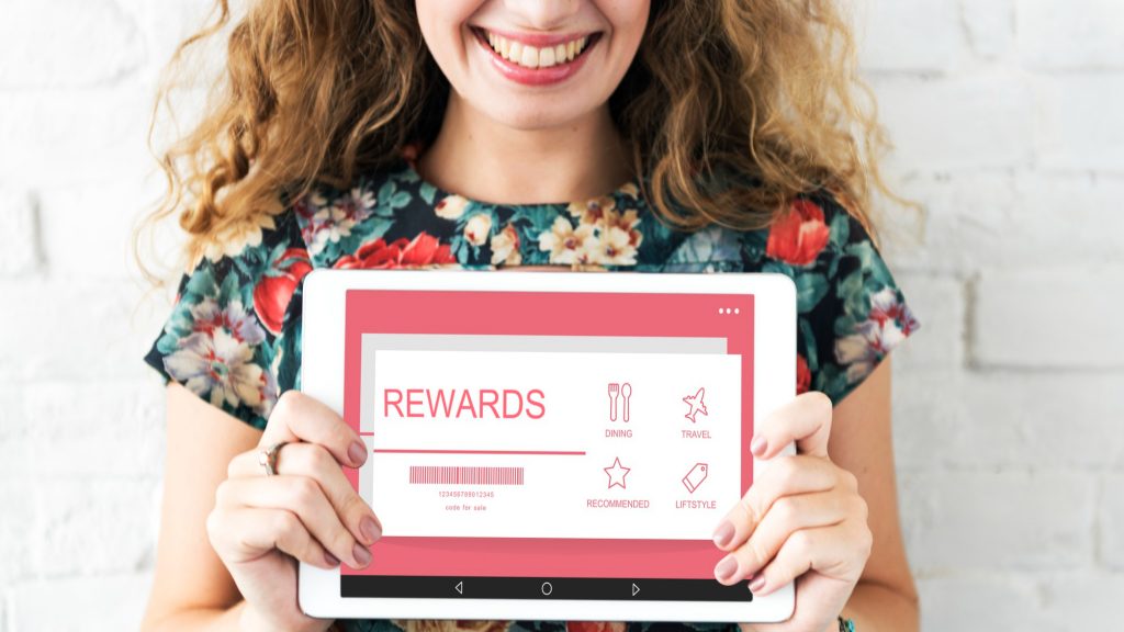 woman holding rewards voucher
