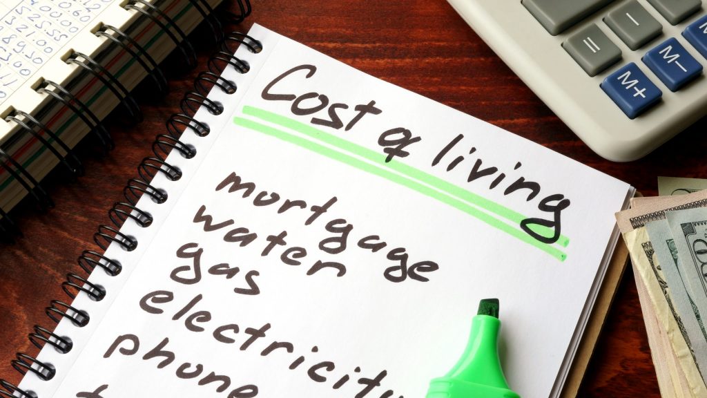 Cost of living written in a notebook and calculations of home fi