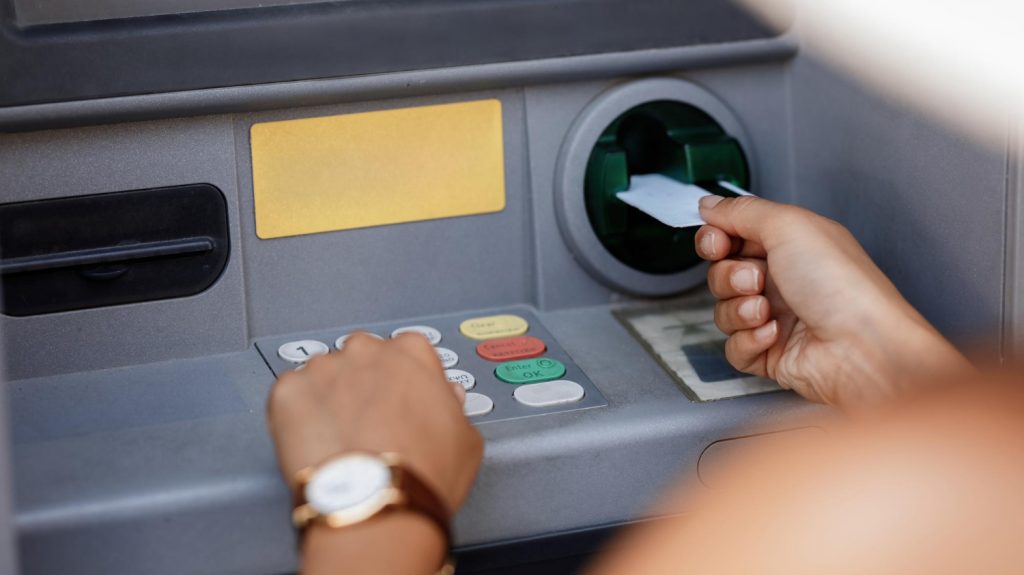 person using ATM bank debit card account