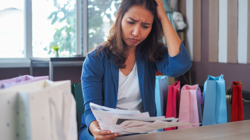 woman sad with credit card bills penalty APR